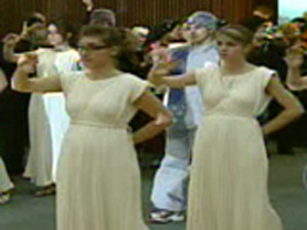 Women in traditional greek outfits welcome the Olympic flame to Montreal's Hellenic Centre 