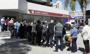 Cypriot bank depositors line up passively to get what's left of their confiscated deposits.