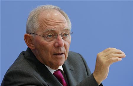 German Finance Minister Schaeuble gestures as he addresses a news conference to presents 2014 federal budget bill in Berlin