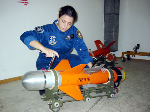 An EAS worker makes adjustments to a missile