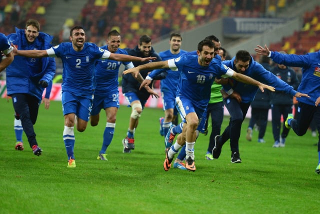 Greece's soccer players celebrating.