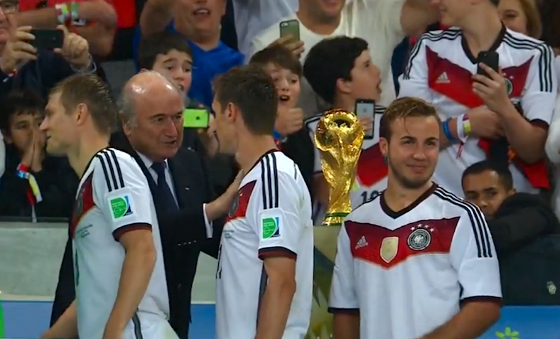 Mario Gotze is happy next to the World Cup Trophy