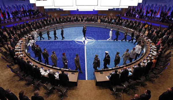 Leaders watch a ceremony honoring NATO military personnel for their service the NATO Summit meeting in Chicago