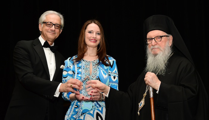 George S. Tsandikos, Leadership 100 Chairman, left, and Archbishop Demetrios present the Archbishop Iakovos Leadership 100 Award for Excellence to Dr. Panagiota Andreopoulou.