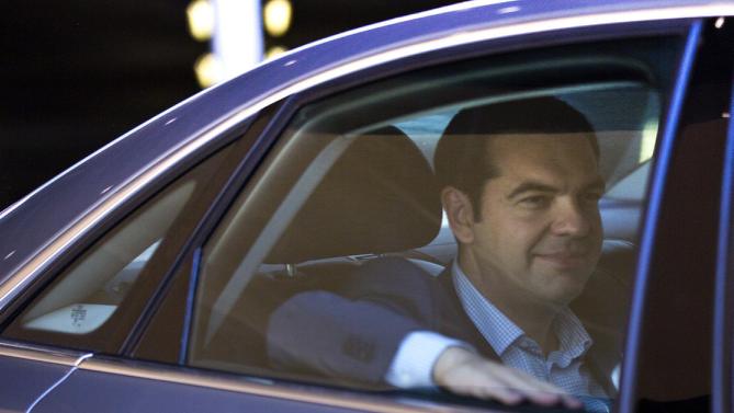 Greek Prime Minister Alexis Tsipras leaves in his car after a meeting at EU headquarters in Brussels on Wednesday, June 24, 2015. Eurozone finance ministers meet Wednesday to discuss the Greek bailout. (AP Photo/Virginia Mayo)