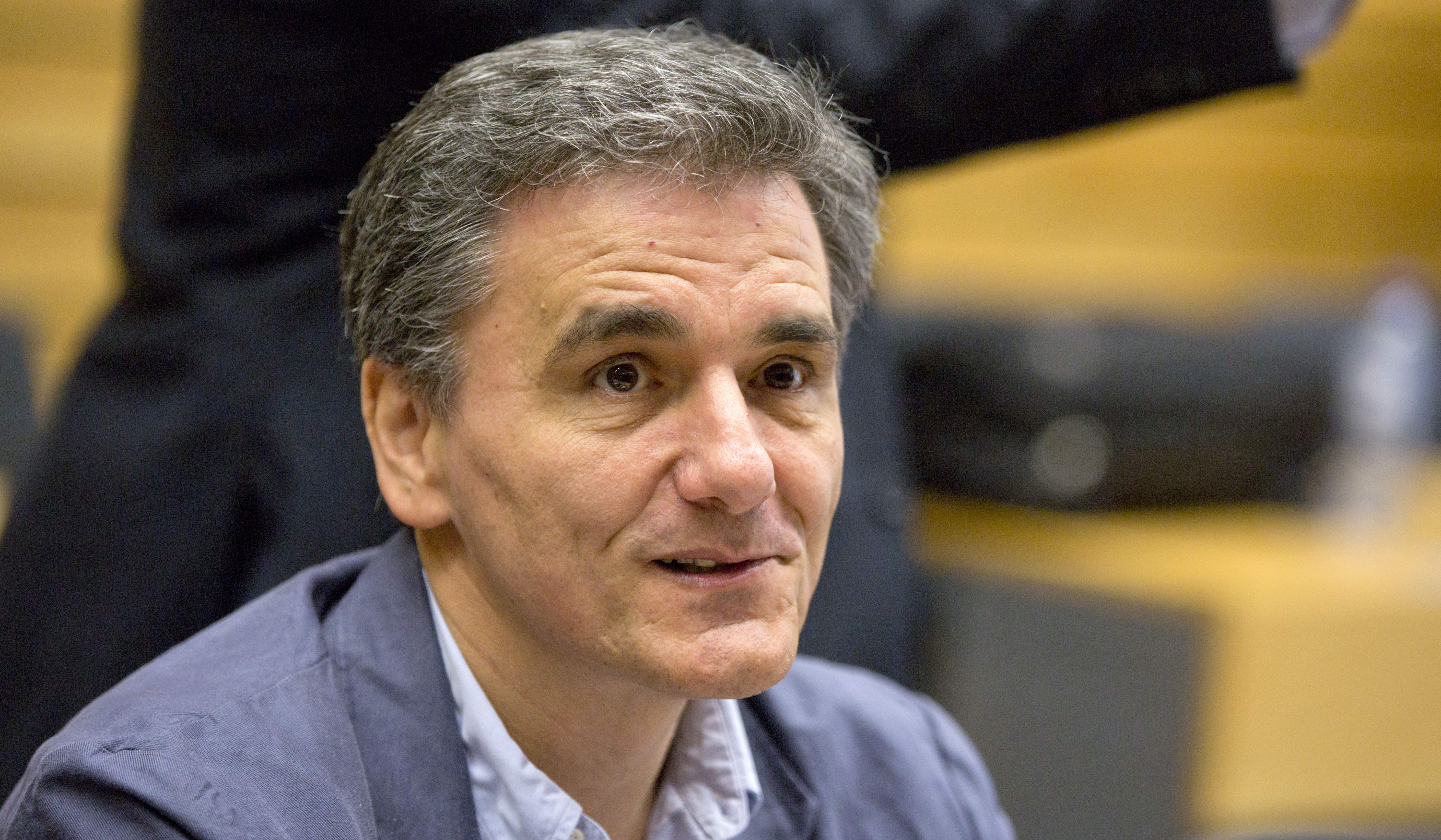 Greek Finance Minister Euclid Tsakalotos waits for the start of a round table meeting of eurozone finance ministers at the EU LEX building in Brussels on Tuesday, July 7, 2015. Greek Prime Minister Alexis Tsipras was heading Tuesday to Brussels for an emergency meeting of eurozone leaders, where he will try to use a resounding referendum victory to eke out concessions from European creditors over a bailout for the crisis-ridden country. (AP Photo/Virginia Mayo)
