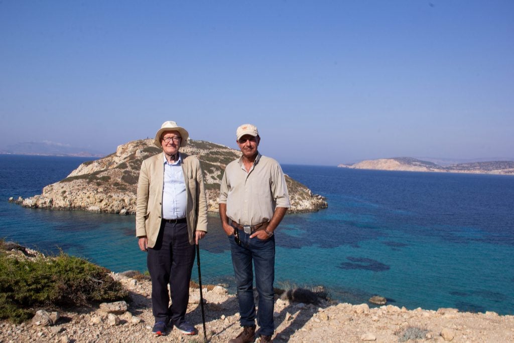 Professor Colin Renfrew and Dr. Kostas Paschalidis at the site of Kavos, on Keros with the islet of Dhaskalio in the background.
