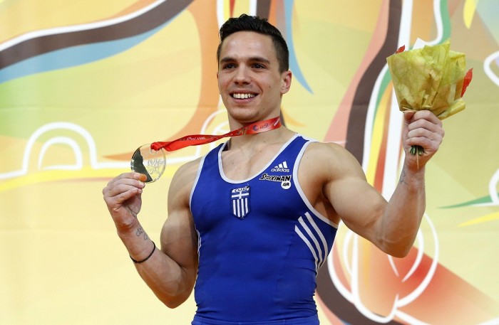 epa04710493 Greek gymnast Eleftherios Petrounias holds his gold medal after winning the Men's rings final at the Men's European Artistic Gymnastic Championships in Montpellier, France, 18 April 2015. EPA/GUILLAUME HORCAJUELO