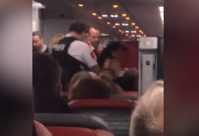 A stripped woman who tried to storm the cockpit shouting 