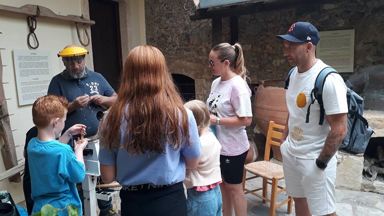 Adults and children attending a woodturning workshop at the Museum of Rural Life in Crete, September 23, 2022.