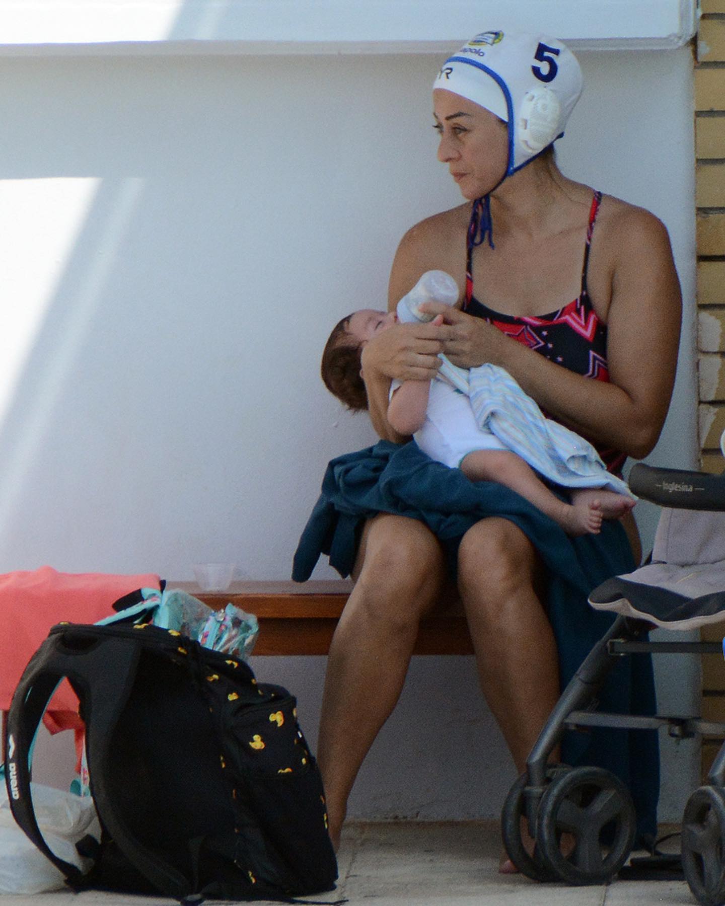 Greek water polo player feeding baby