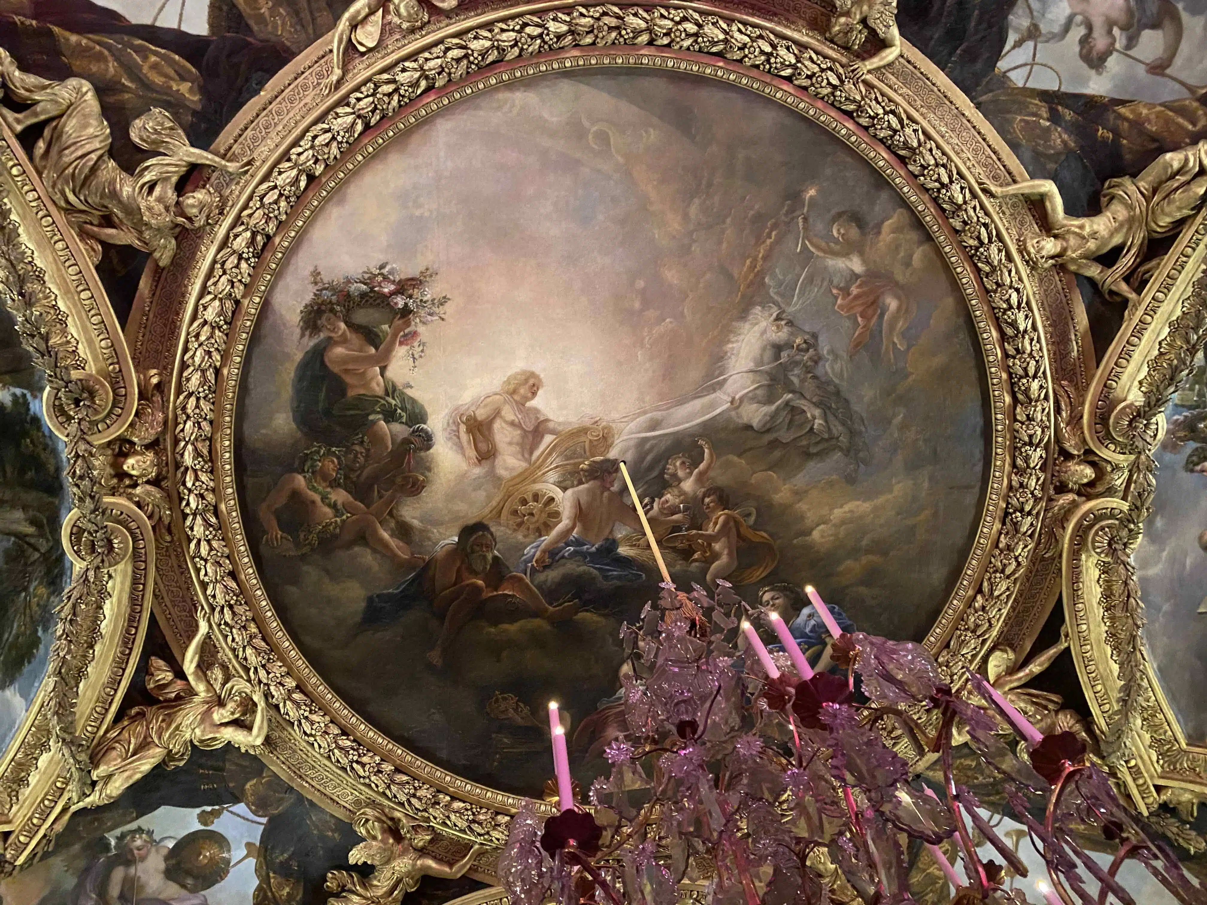Greek god Apollo riding a chariot on a ceiling at Versailles palace.