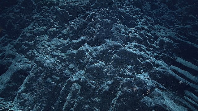 A captivating view of the colossal undersea crater hosting an awe-inspiring volcano
