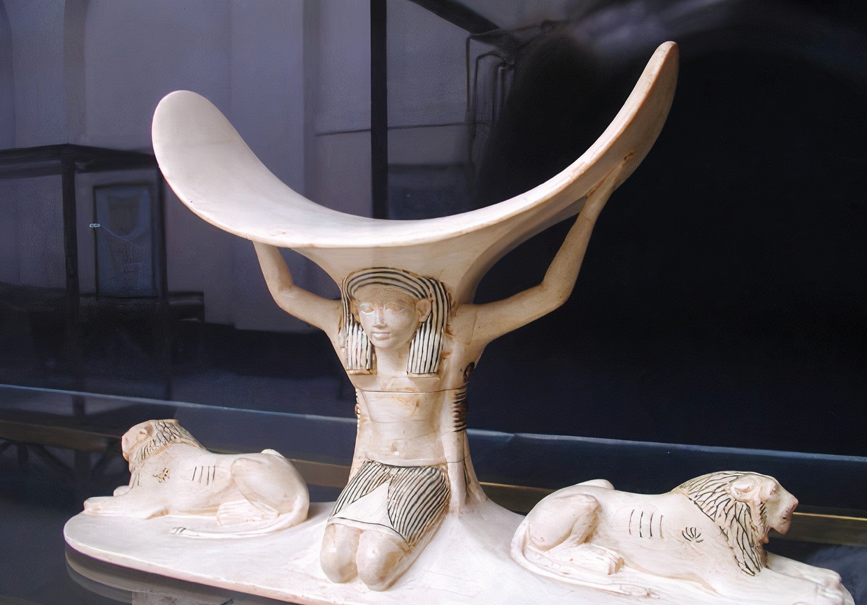 Egyptian headrest showing Shu holding up the sky