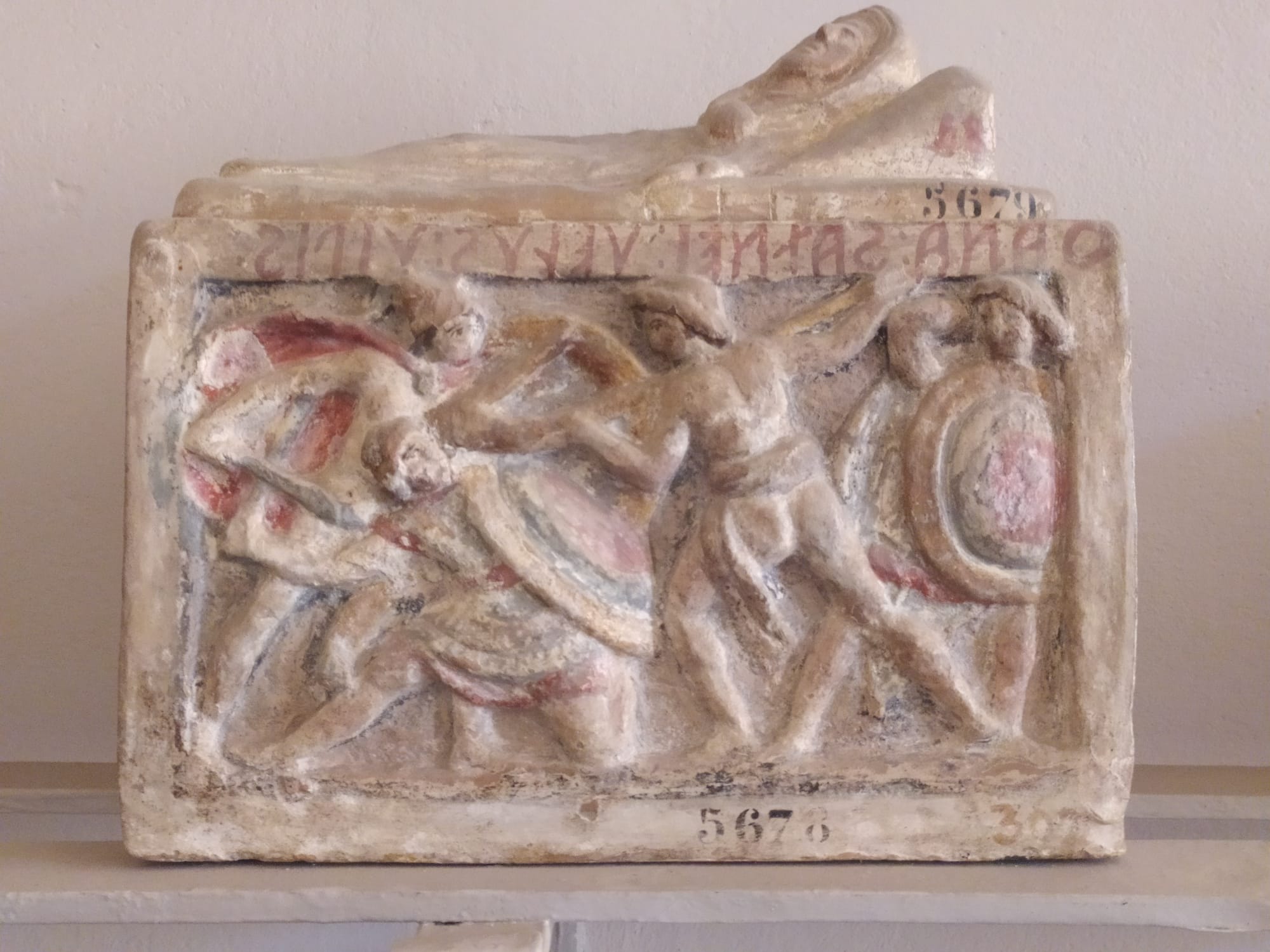 etruscan basrelief with inscription and mythological scene