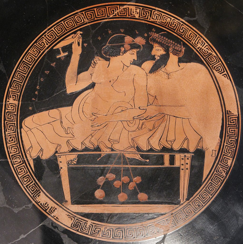 Man and a haetera reclining on a bench during a banquet; kalos inscription. Tondo from an Attic red-figure kylix. 