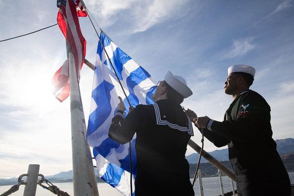 Sailors of USS Gerald R. Ford , the largest aircraft carrier in the world, raise the US and Greek flags upon arrival at Souda Bay, Crete, Greece