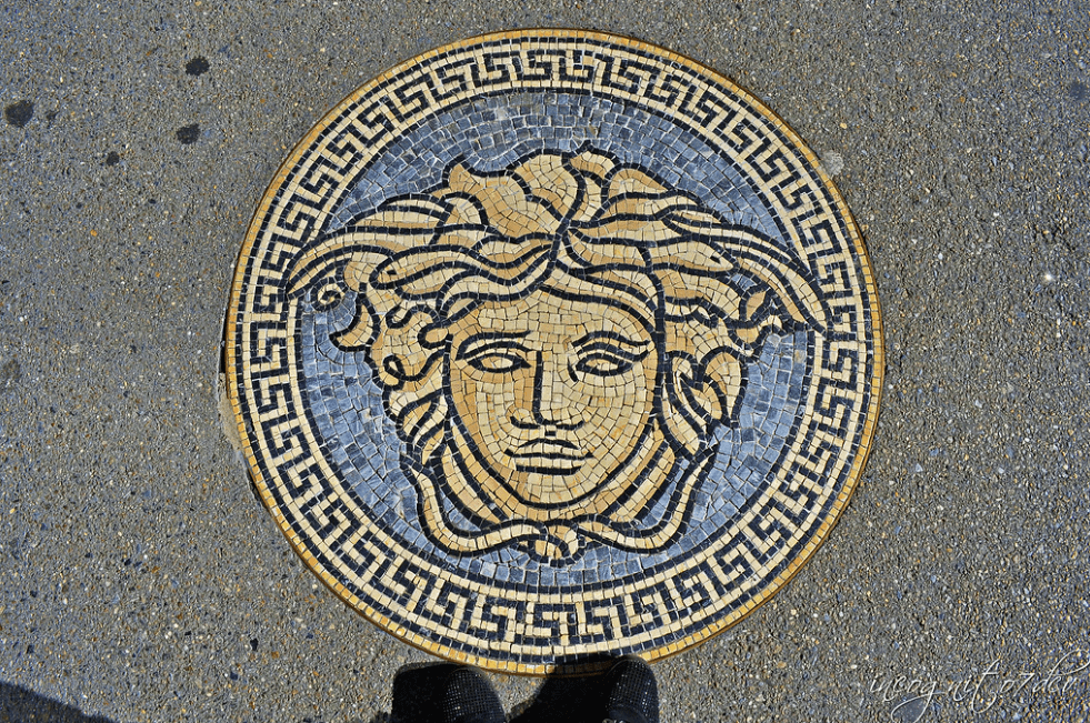 A mosaic of Medusa embedded in a pavement, symbol of Versace , inspired by Greek mythology
