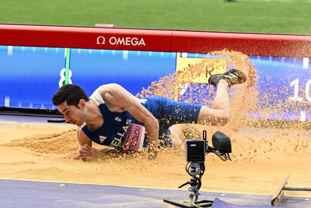 Miltos Tentoglou lands in the sand pit during his gold medal-winning long jump at the Paris Olympics.