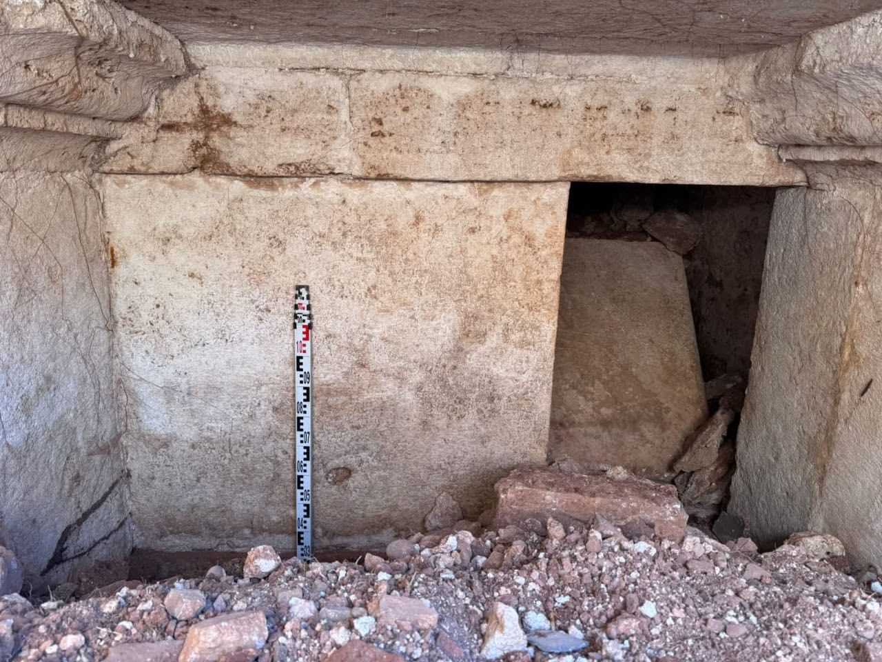 Archaeologists work at a Roman-era tomb in Strikçan, Albania, where a rare bilingual inscription was discovered