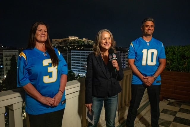Charge d’Affaires astatine  the US Embassy successful  Athens, Maria Olson with Chargers fans Debbie and Steve Stackiewicz.