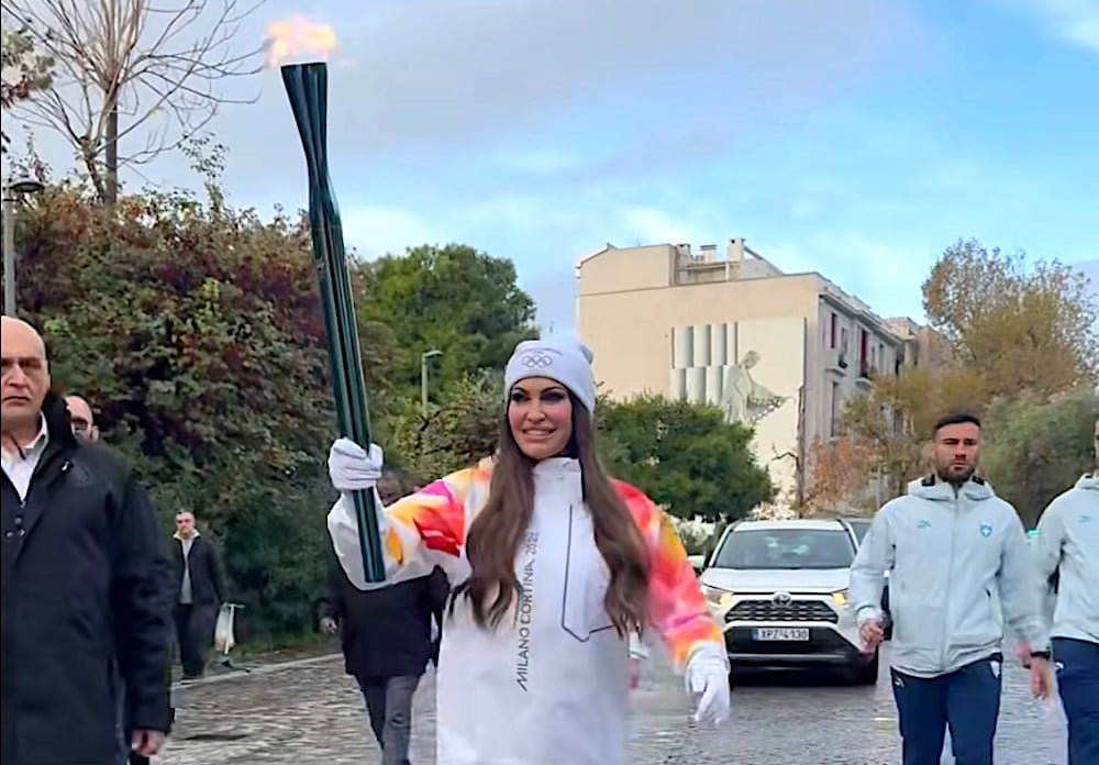 U.S. Ambassador Kimberly Guilfoyle Carries Olympic Flame in Athens Relay