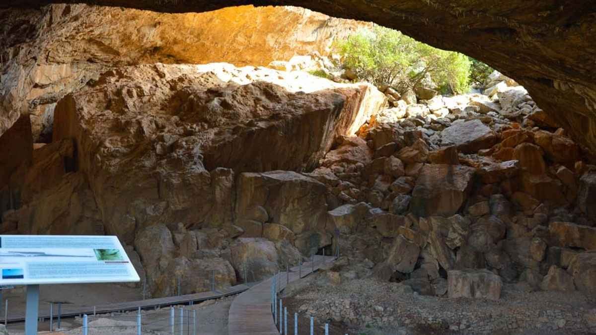 Interior view of Franchthi Cave showing rocky formations and excavation pathways.