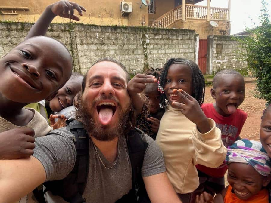 Nikos Leontis meets with local children during his motorbike journey across Africa.