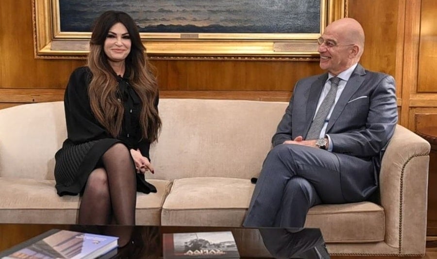 Ambassador Kimberly Guilfoyle and Greek Defense Minister Nikos Dendias (pictured sitting) seal a defense agreement between Greece and Florida.