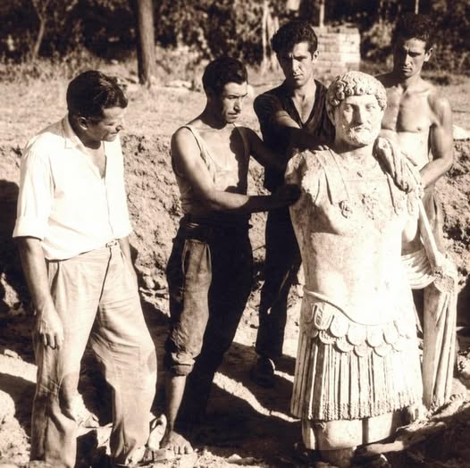 Archaeologists and workers display the statue of Hadrian of Thasos when it was discovered on the Greek island.