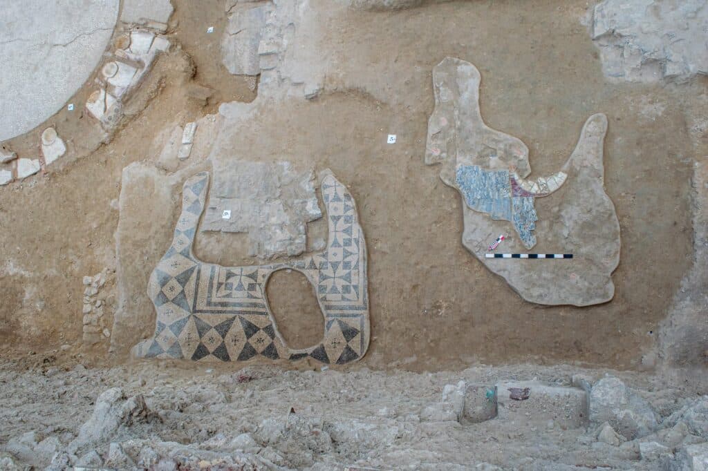 Surviving fragments of intricate mosaic flooring hint at the former grandeur of a ruined classical villa