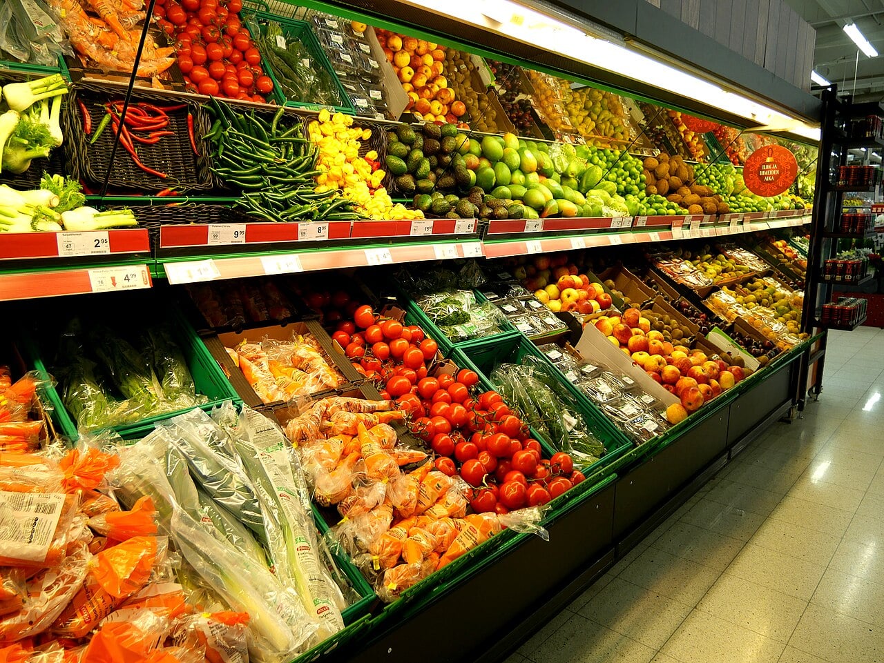 Fresh fruits and vegetables displayed at a market during food safety checks.