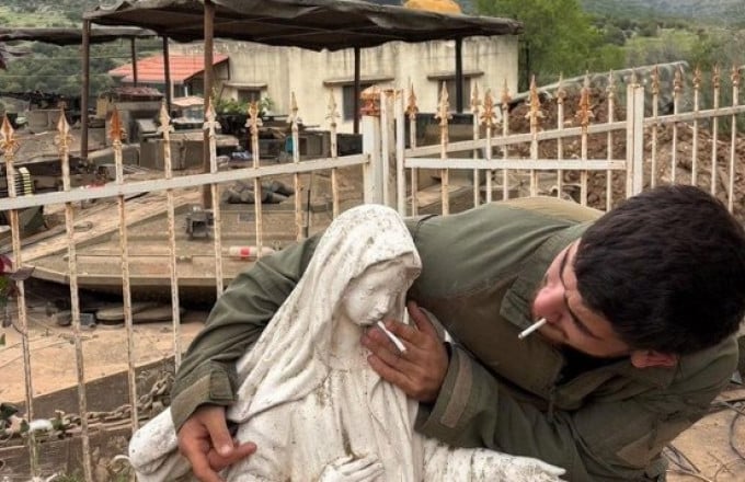 Israeli soldier placing cigarette in virgin mary statue