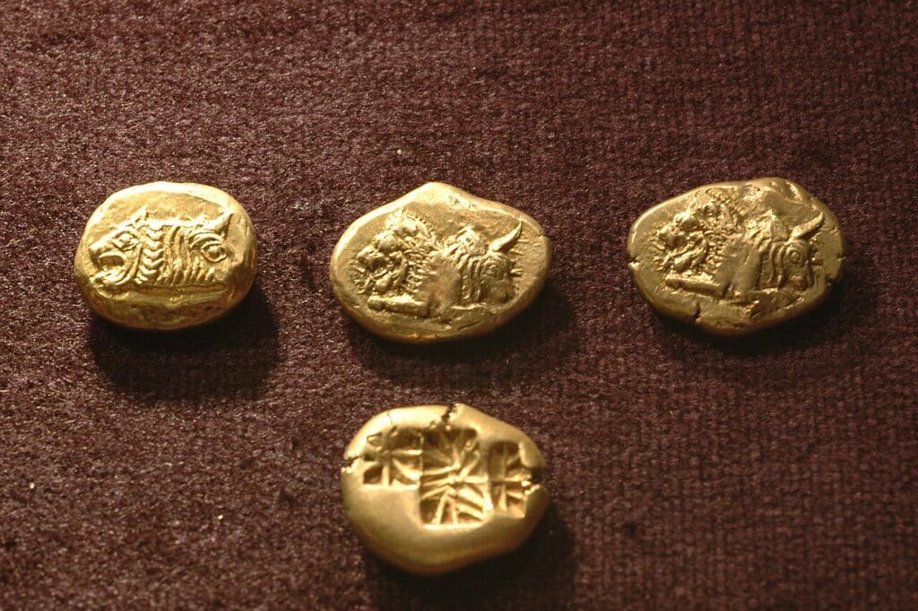 Standard coins from the 6th century BC. The central "lion and bull" one is thought to originate from Lydia.