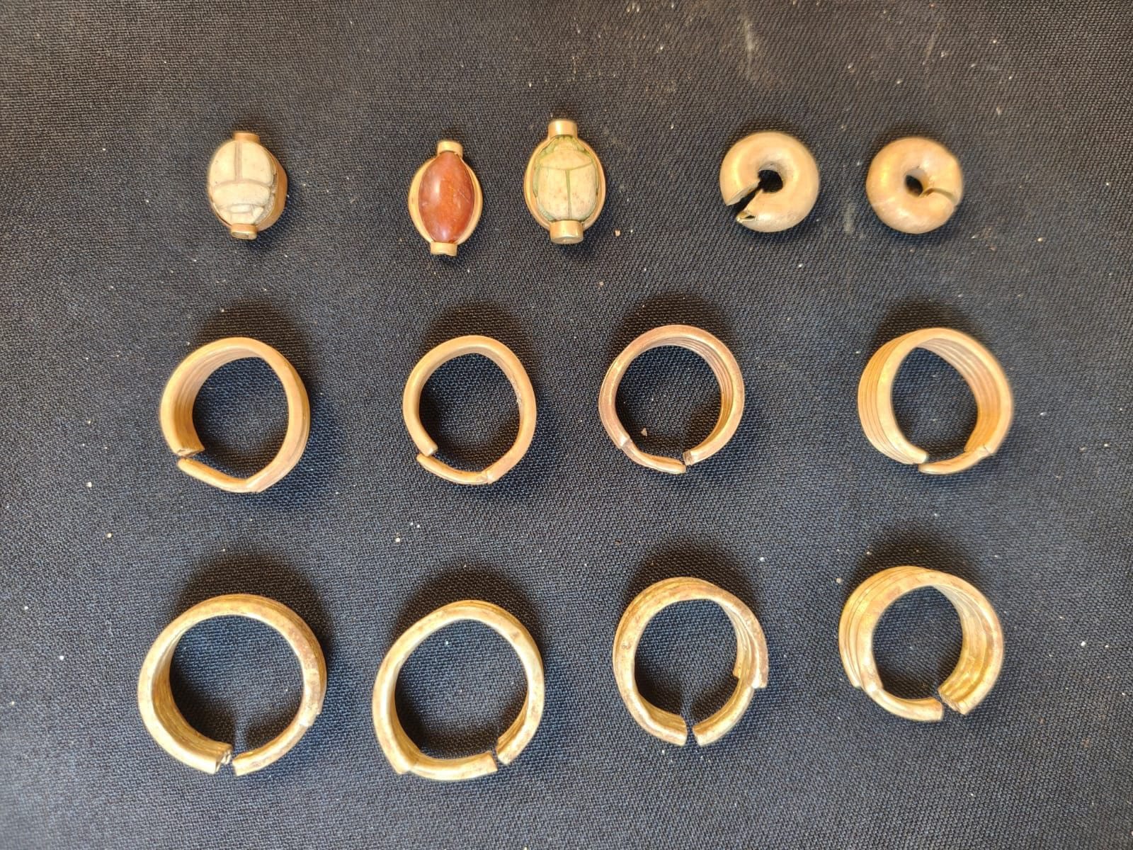 A collection of yellow metal earrings, along with small decorative objects