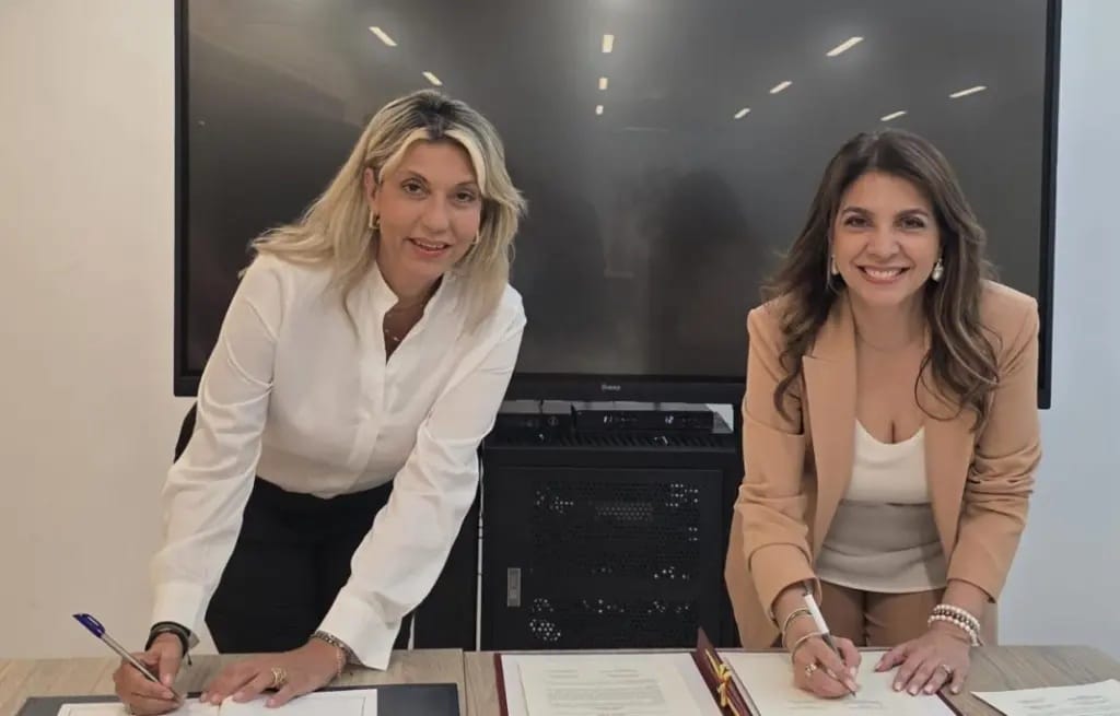 Greece Deputy Minister of Tourism Anna Karamanli (left) and Colombia Ambassador Ligia Quessep sign a tourism agreement.