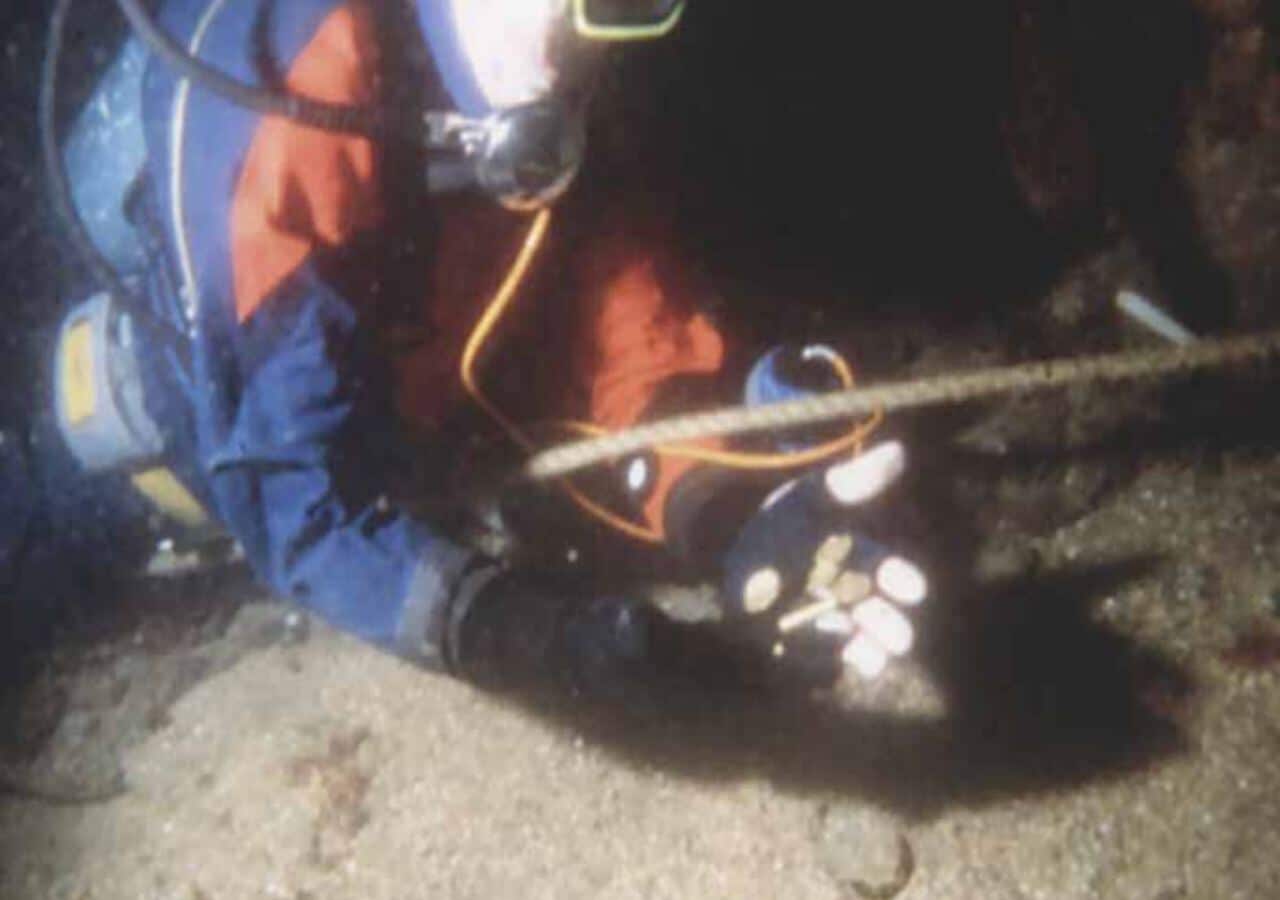 Ron Howell holding the first gold finds at the site, April 30, 1995