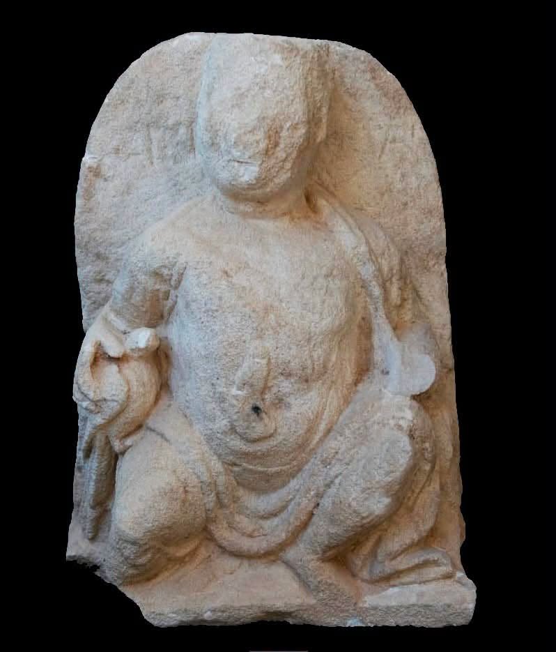 A limestone funerary stele depicting a seated figure