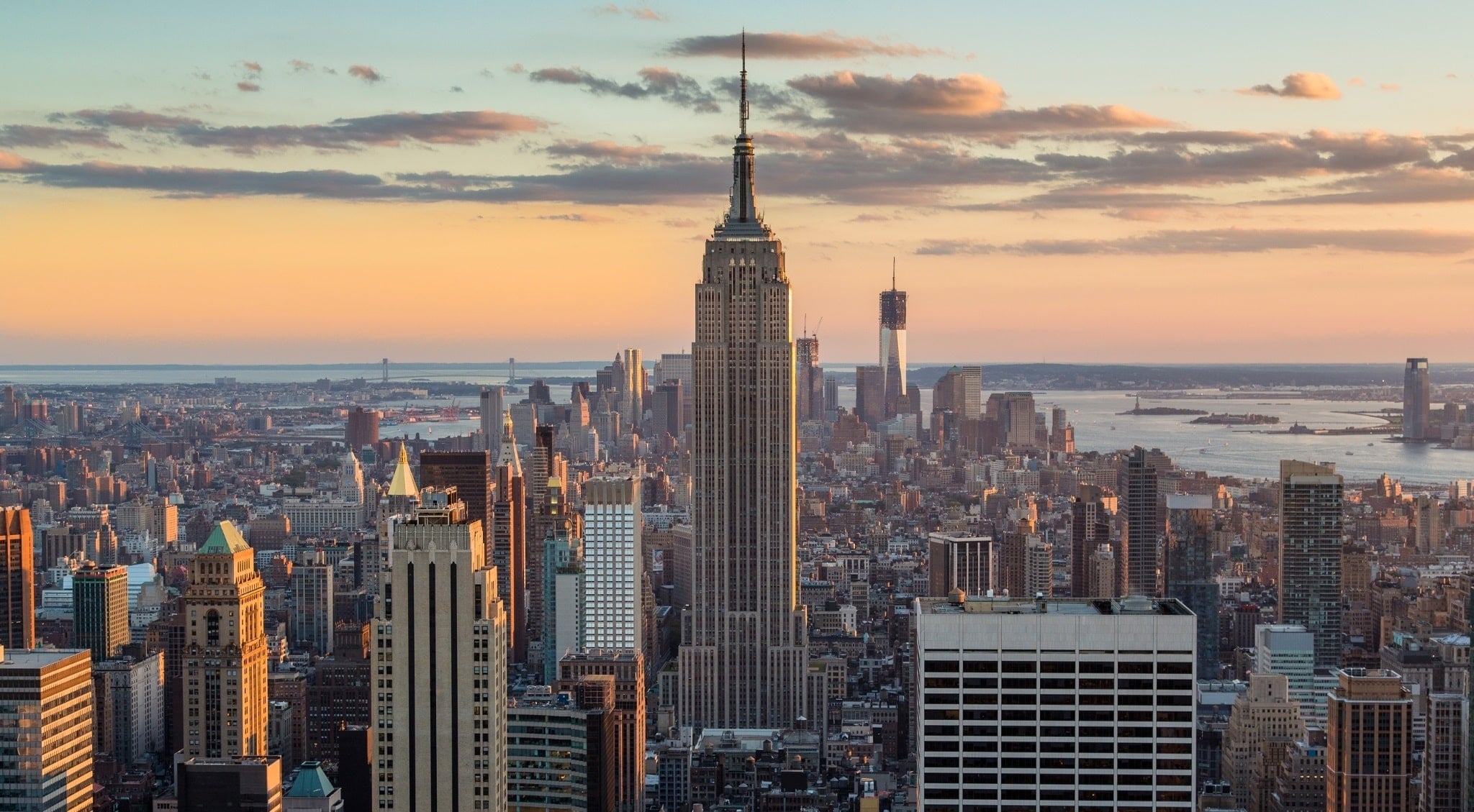 The Empire State Building with its spire visible above the New York City skyline.