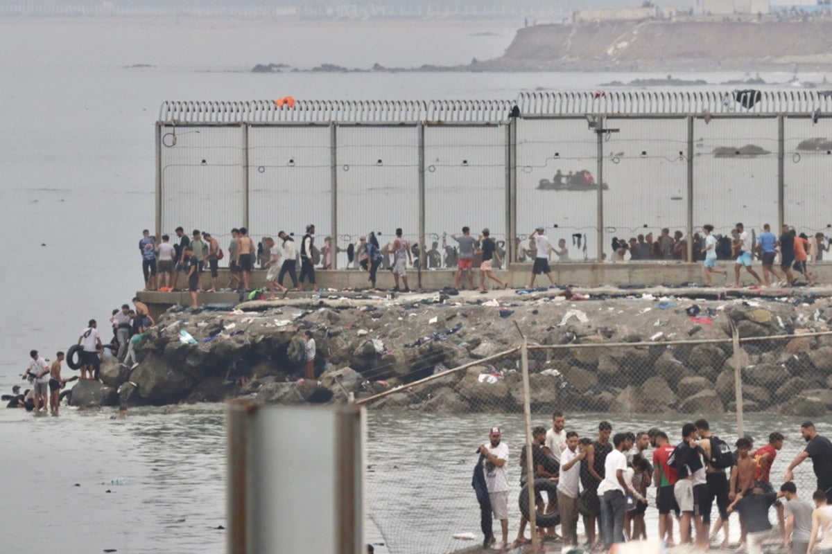 Thousands of migrants enter Spanish enclaves in North Africa