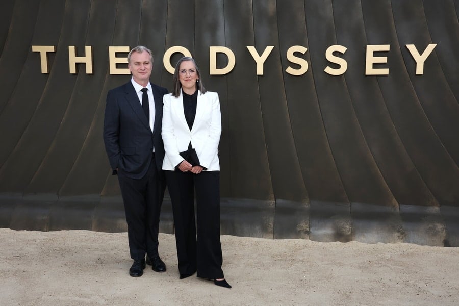 Christopher Nolan and Emma Thomas pose in front of The Odyssey backdrop at the film’s London premiere.