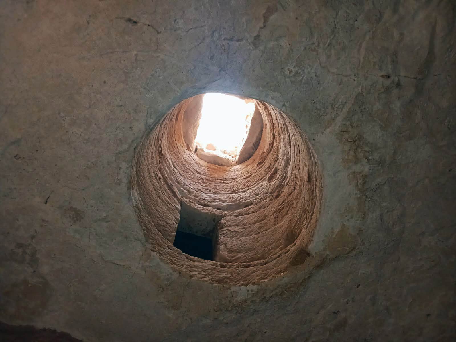 The vertical shaft leading into one of the rock-cut hypogea