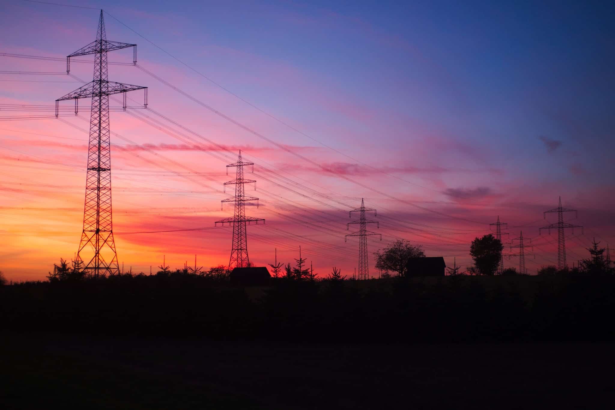 Electricity transmission towers at sunset