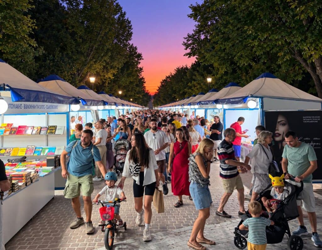 The 54th Book Festival fills the paths of Pedion tou Areos with books and readers as evening falls over Athens.