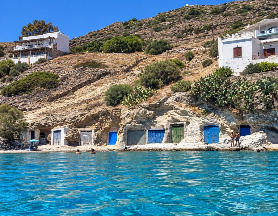 The rocky coastline of Kimolos, where traditional seaside structures blend into the island’s distinctive volcanic landscape.