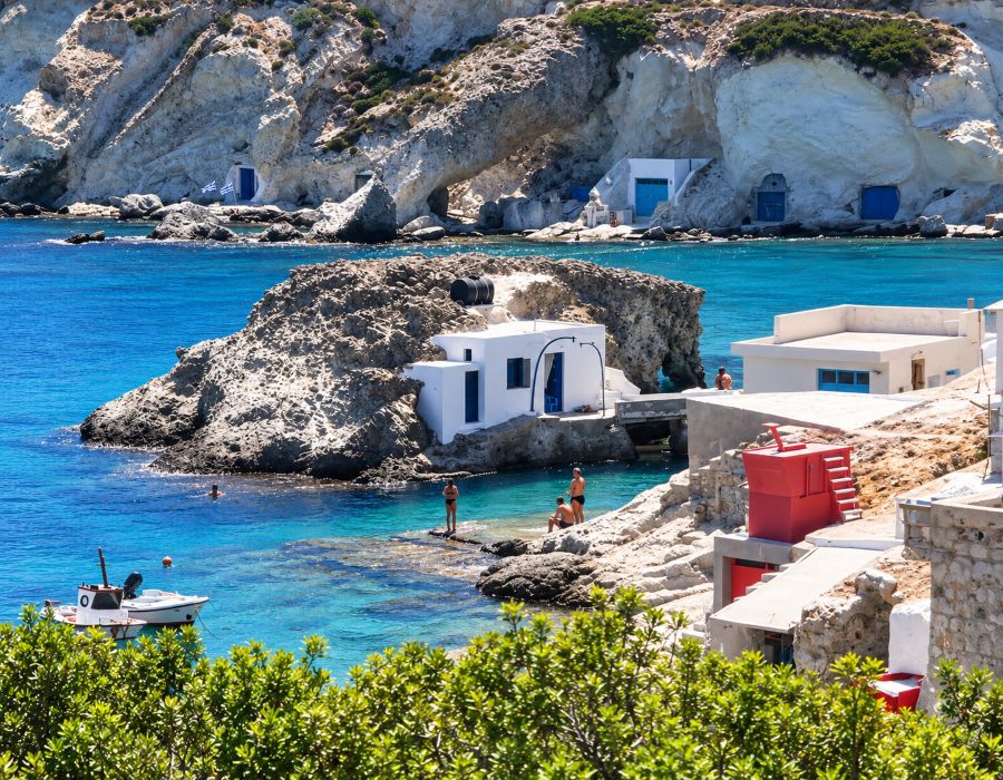The rugged volcanic landscape of Kimolos meets the deep blue waters of the Aegean