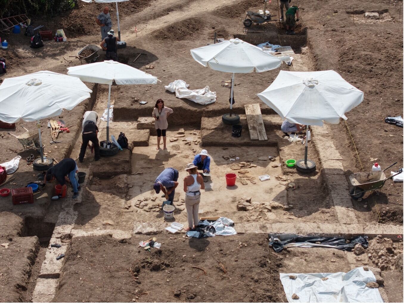 Cleaning the floor of the northern andron, Royal Gymnasium excavation, ancient Mieza