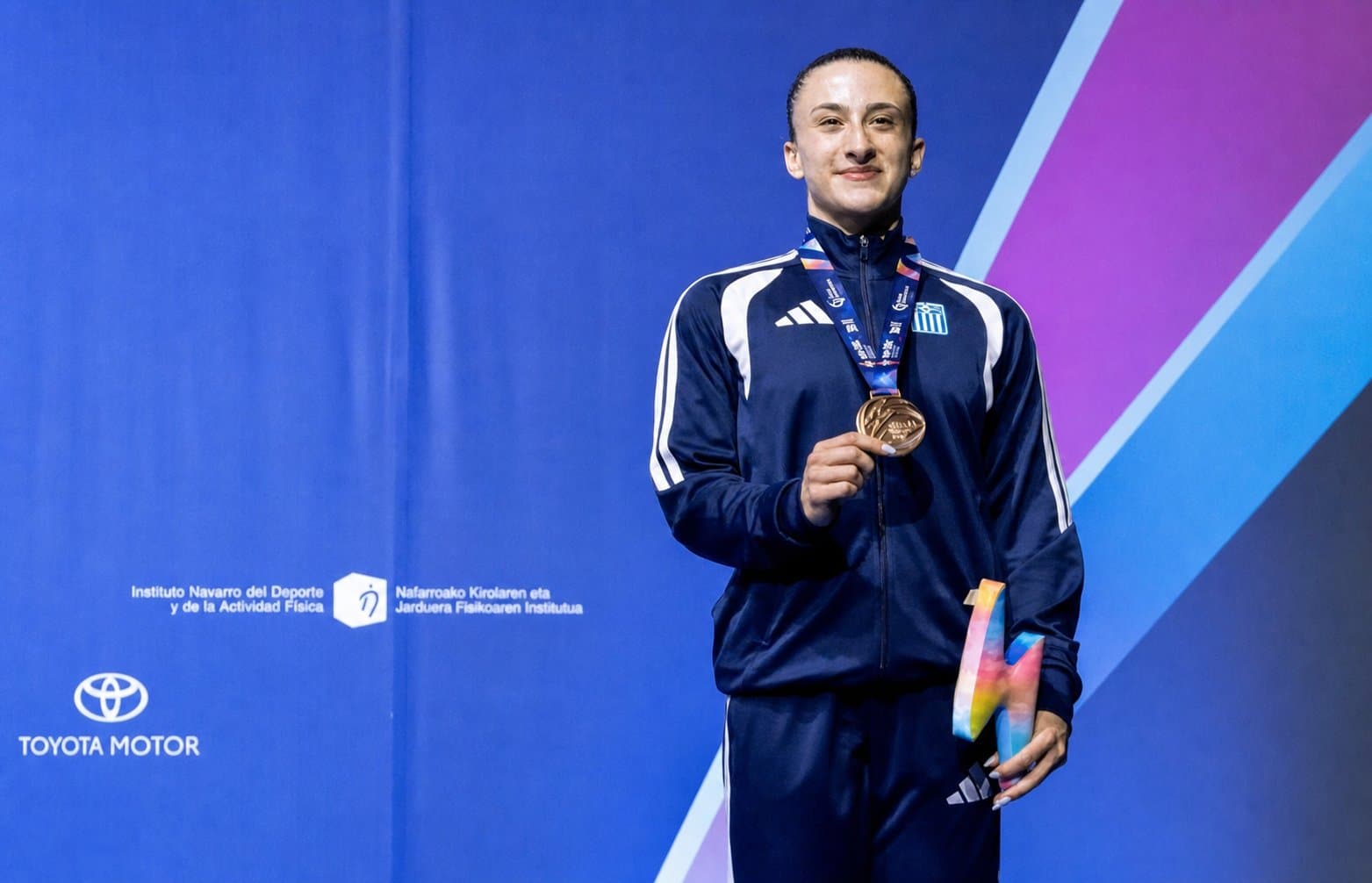 Faidra Diamanti receives her bronze medal, a first for Greece, at the Wolrd Gymnastics championships in Spain. Credit: Hellenic Gumnastics Federation