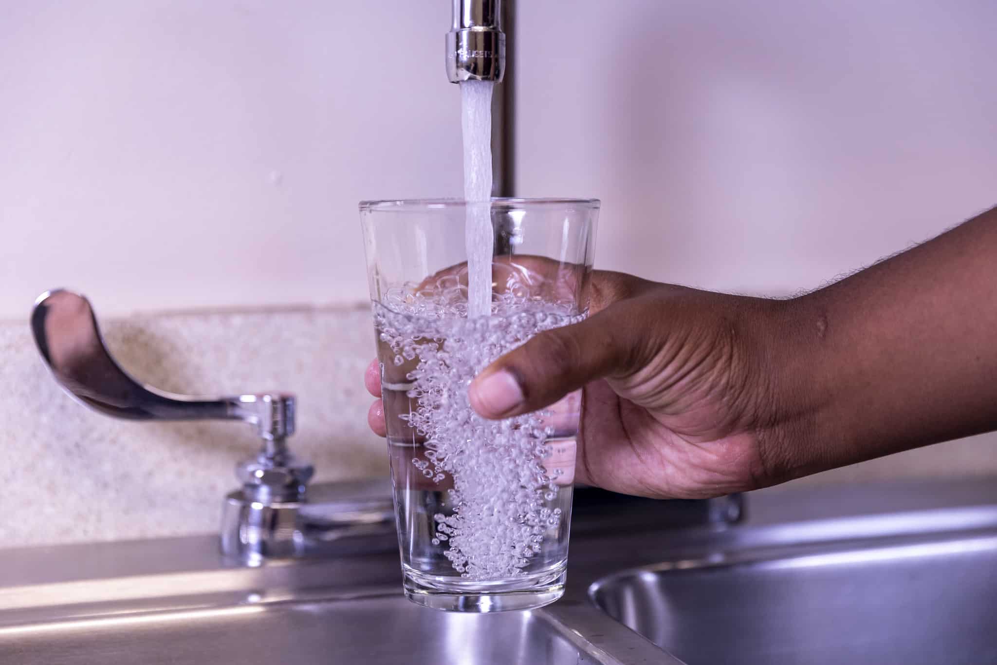 Drinking tap water in glass