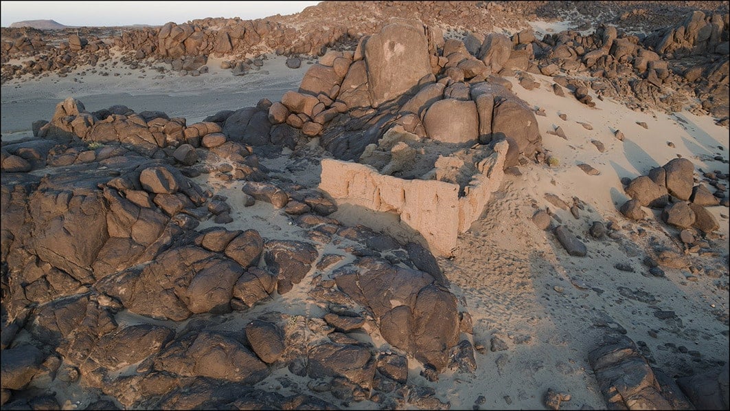 The church of Miseeda with the petroglyph visible on the rock behind it